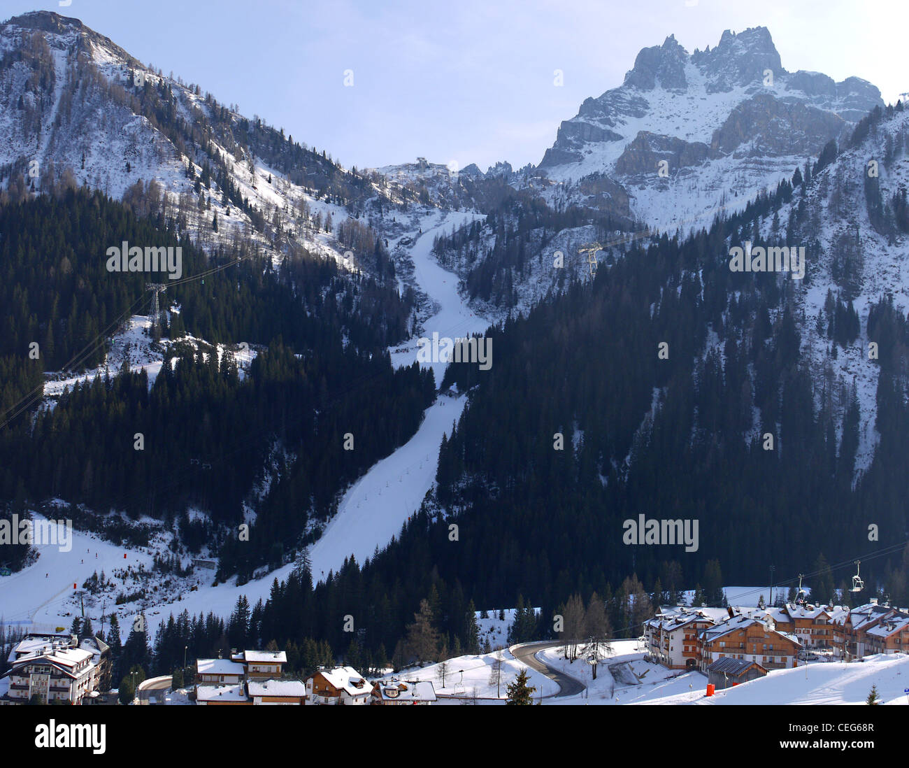 Steep ski run into Arabba ski resort in the Dolomite mountains of Italy Stock Photo