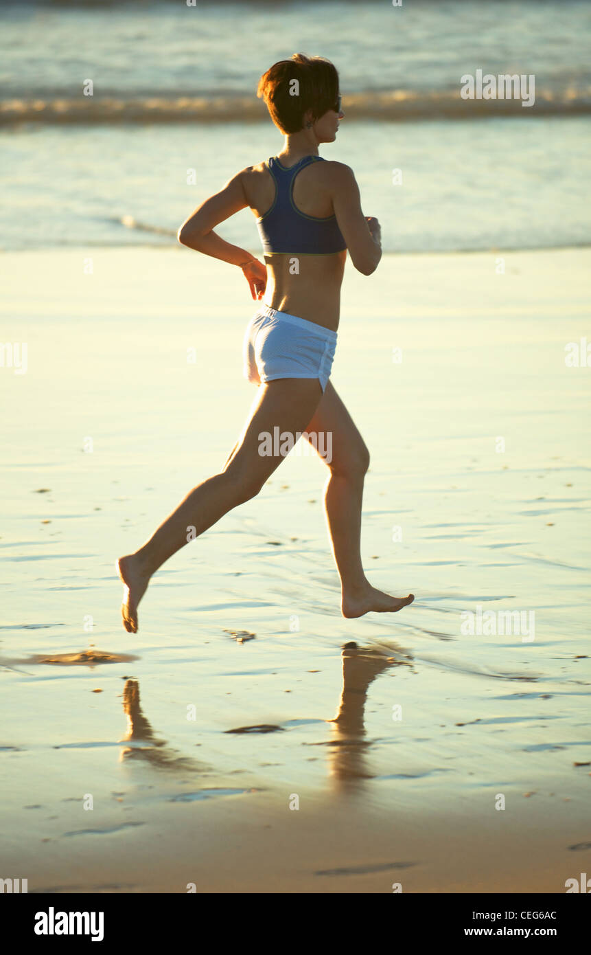 A woman running on the beach. Stock Photo