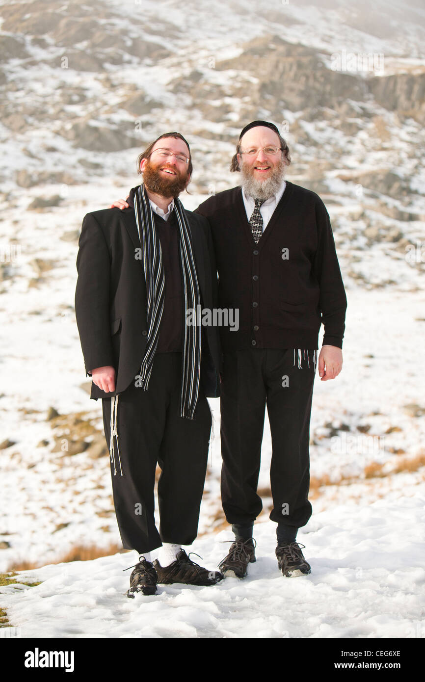 Two Jewish men on kirkstone Pass above Ambleside in the Lake District in snow. UK. Stock Photo