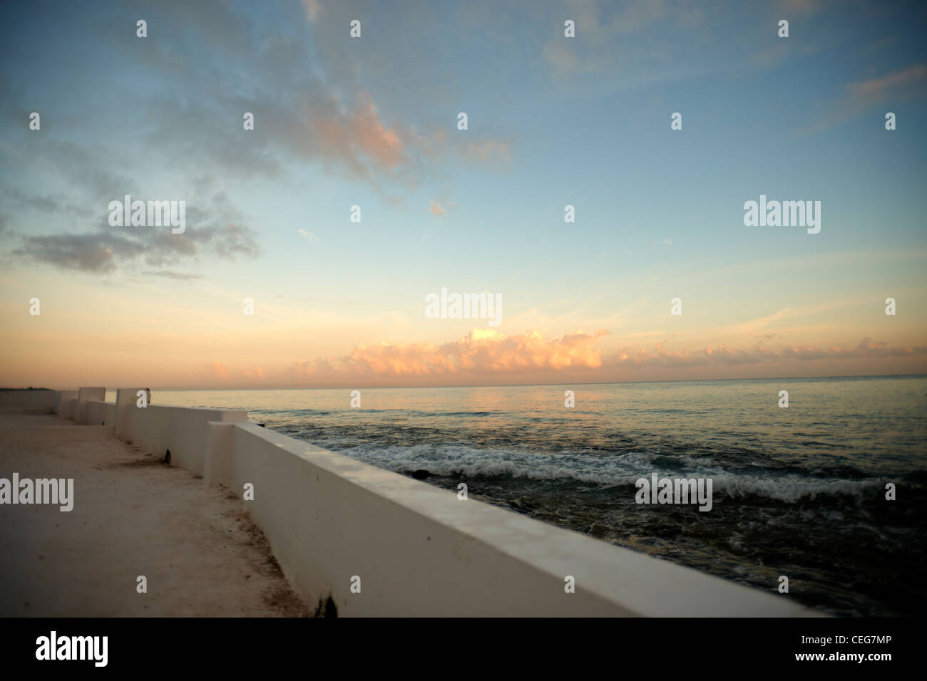 View of the Pacific Ocean at sunset, from the vantage point of a seawall Stock Photo