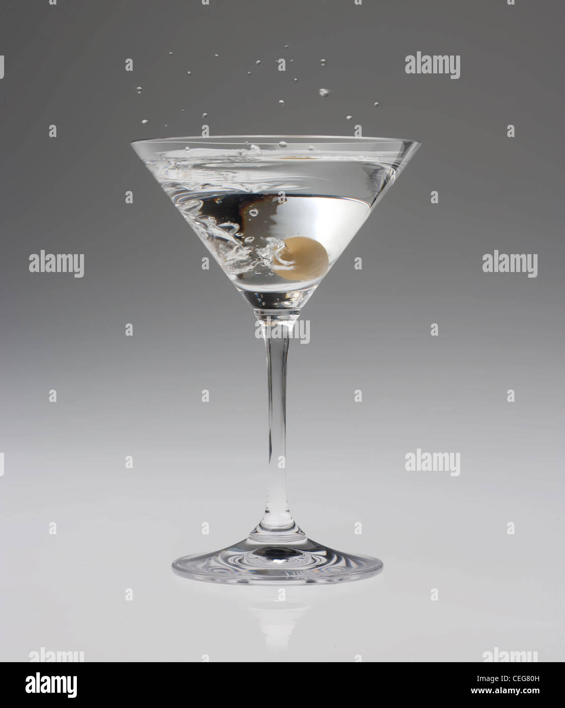 an olive dropped into a Martini makes a splash Stock Photo