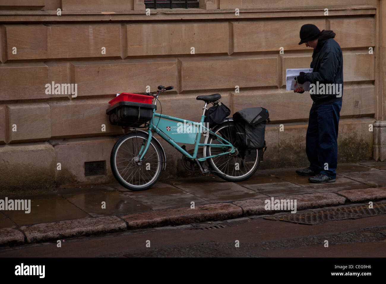 Cambridge University courier with bicycle Stock Photo Alamy