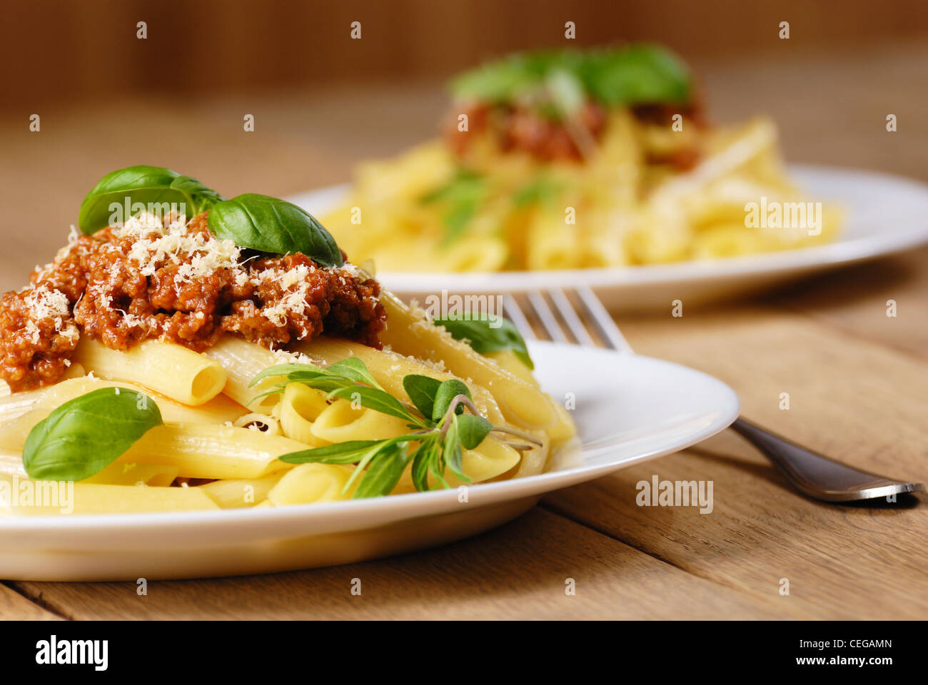 Rigatoni pasta with a tomato beef sauce in the white plate Stock Photo