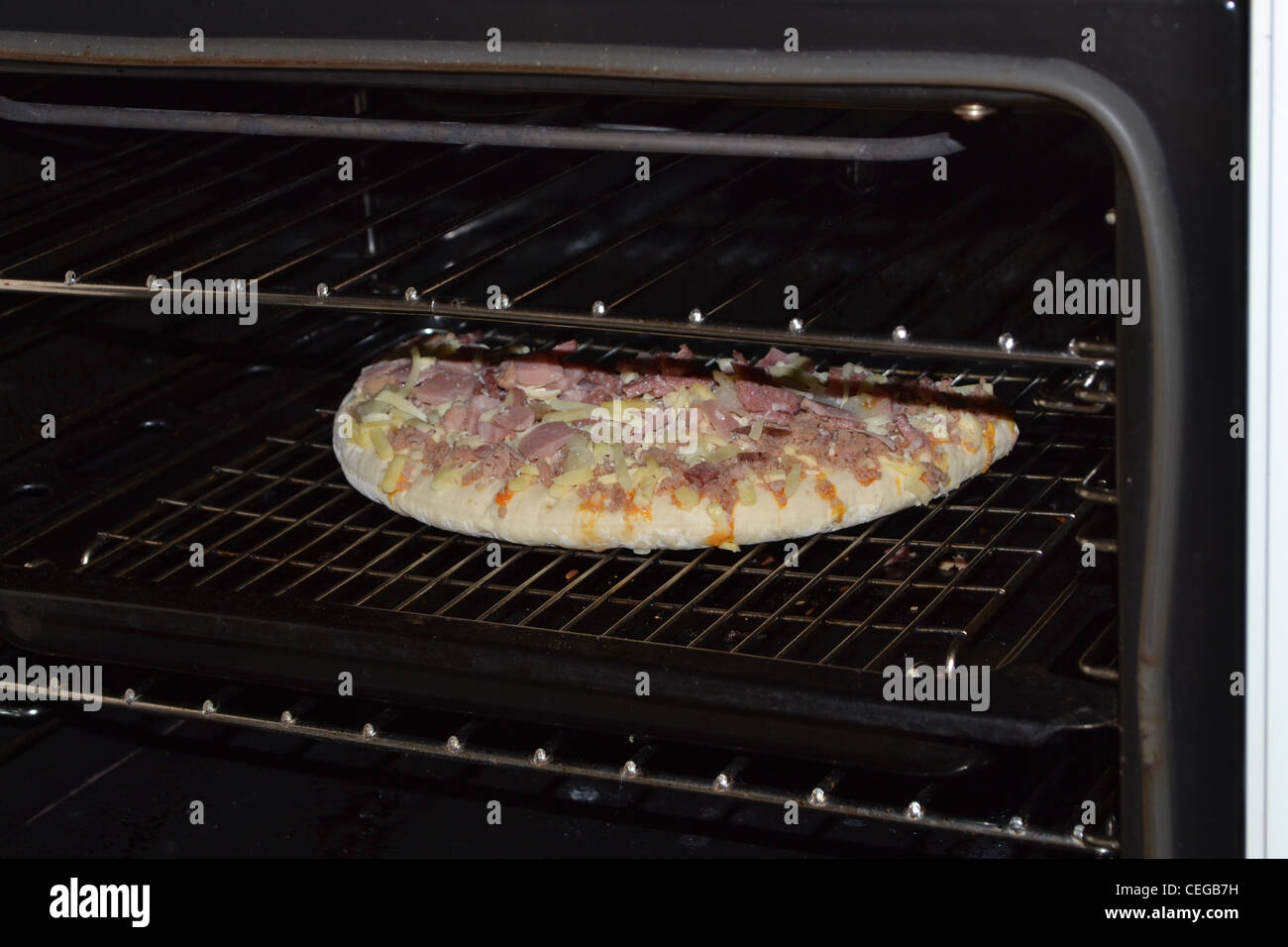 Frozen pizza going into the oven Stock Photo Alamy