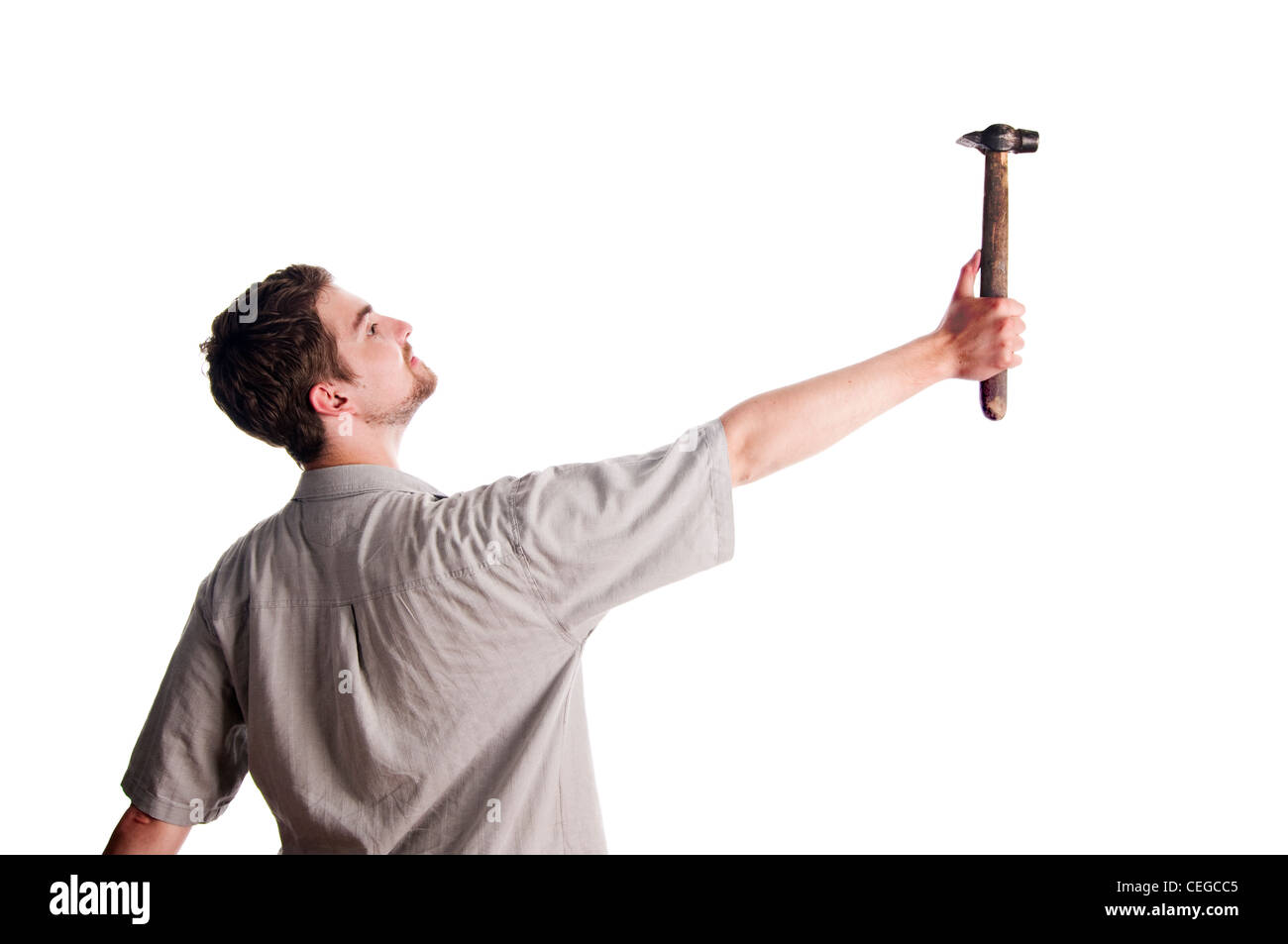 Young man hitting something with the hammer Stock Photo Alamy