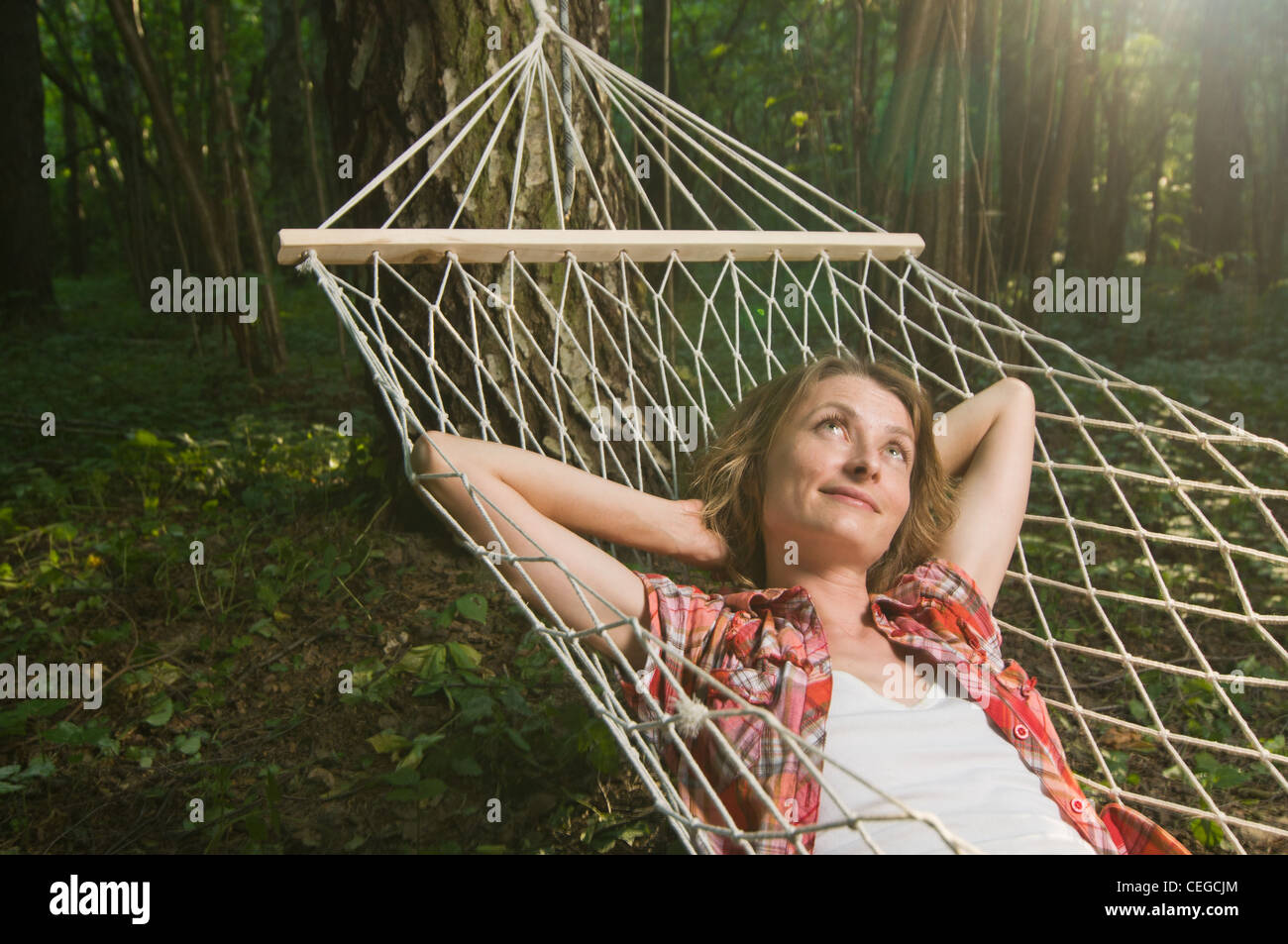 Beautiful woman relaxing in hammock out in the woods Stock Photo - Alamy