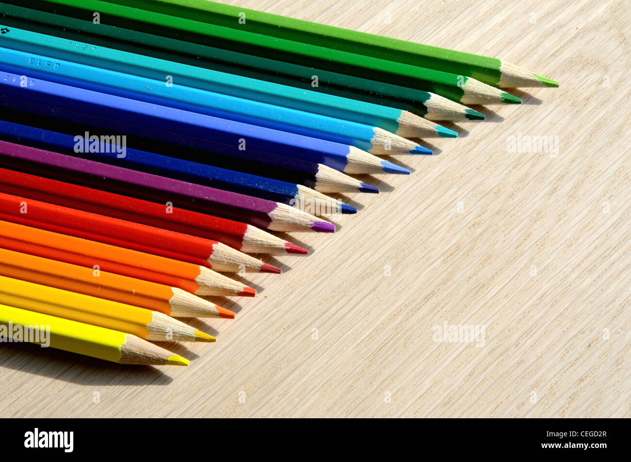 Beautiful colored pencils on a wood texture Stock Photo - Alamy