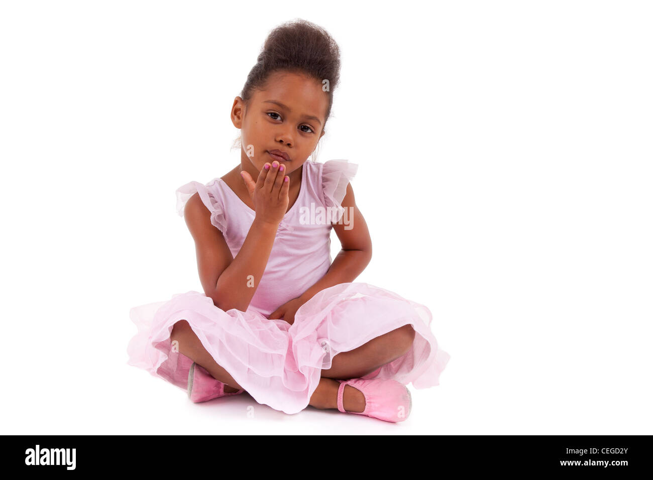Cute little African Asian girl sitting on the floor, isolated on white ...