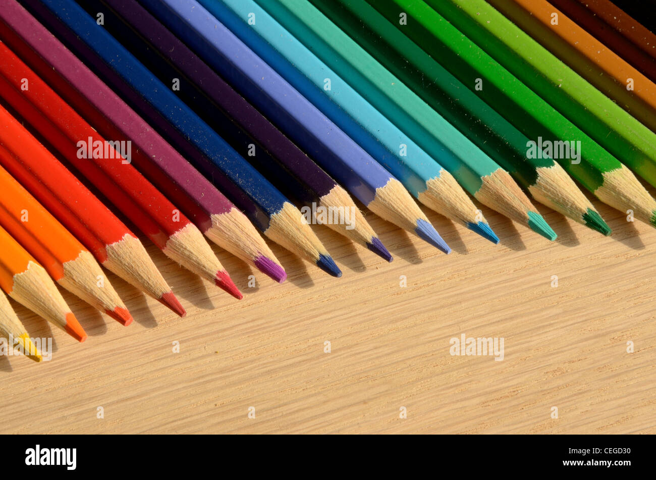 Beautiful colored pencils on a wood texture Stock Photo - Alamy