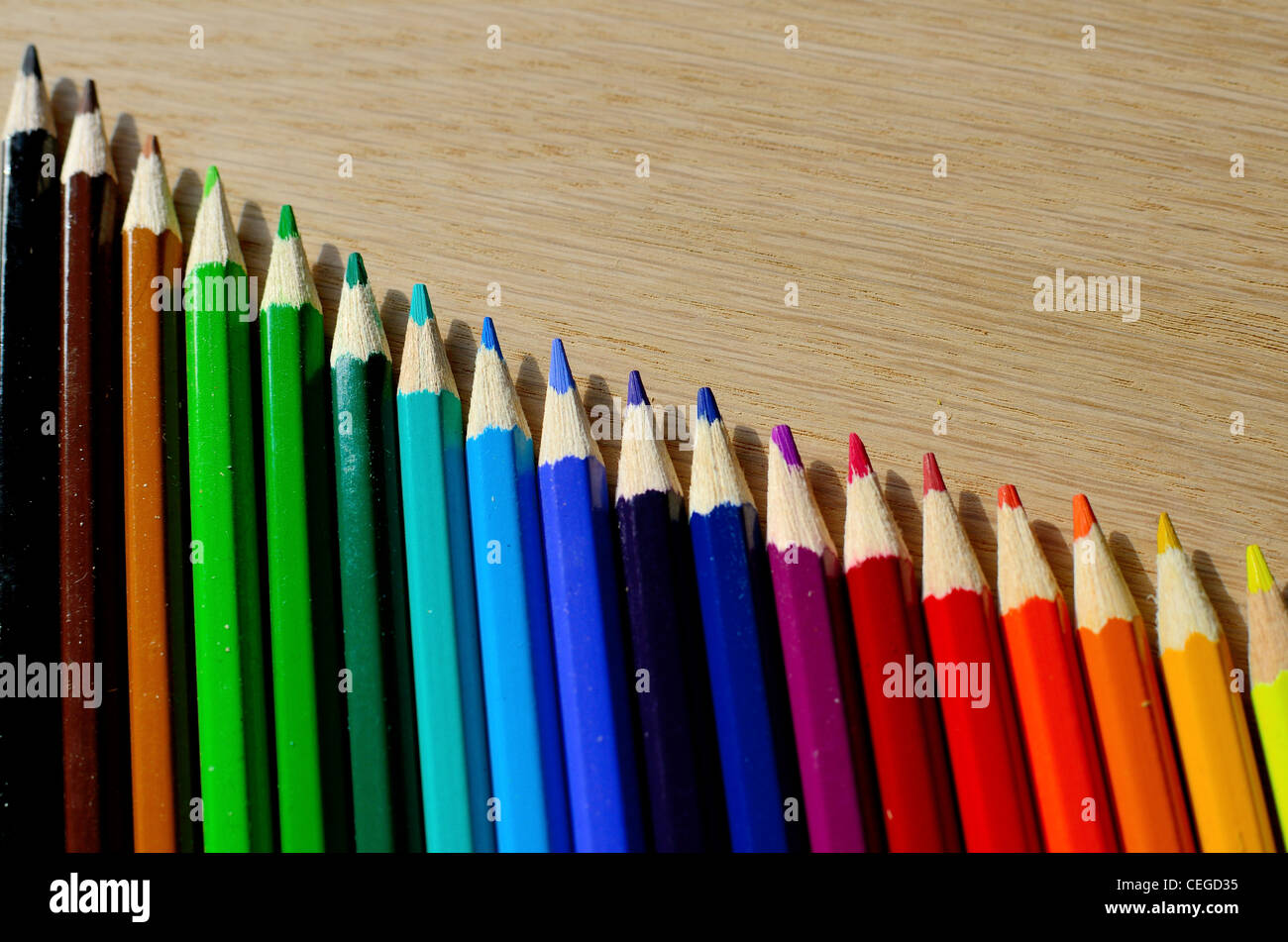 Beautiful colored pencils on a wood texture Stock Photo - Alamy