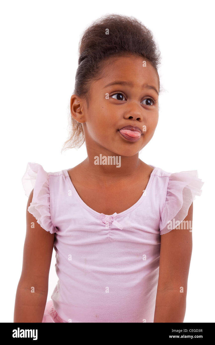 Cute little African Asian girl sticking tongue out, isolated on white ...