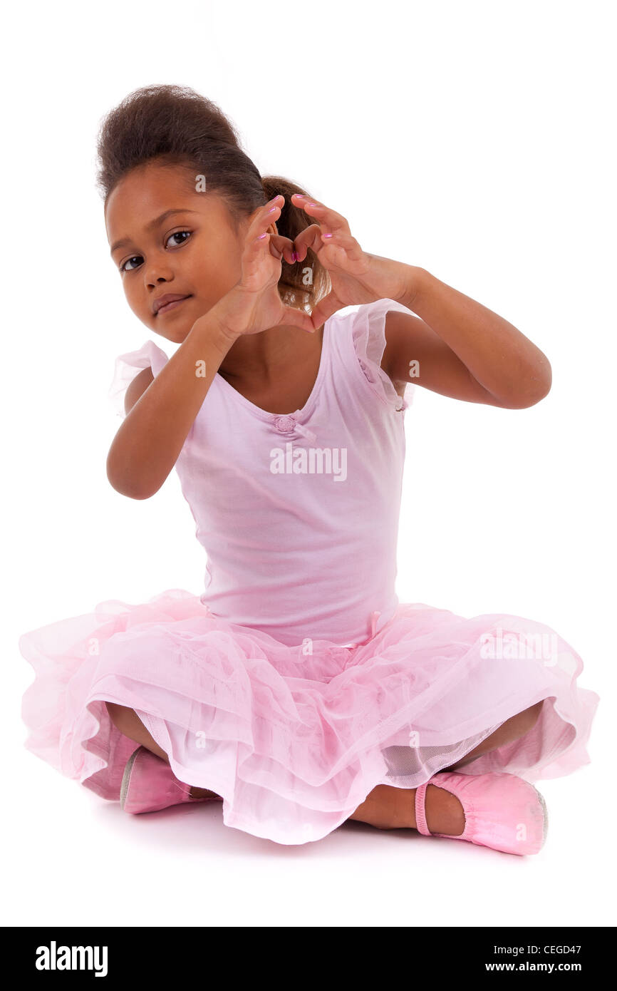 Cute little African Asian girl sitting on the floor, isolated on white ...