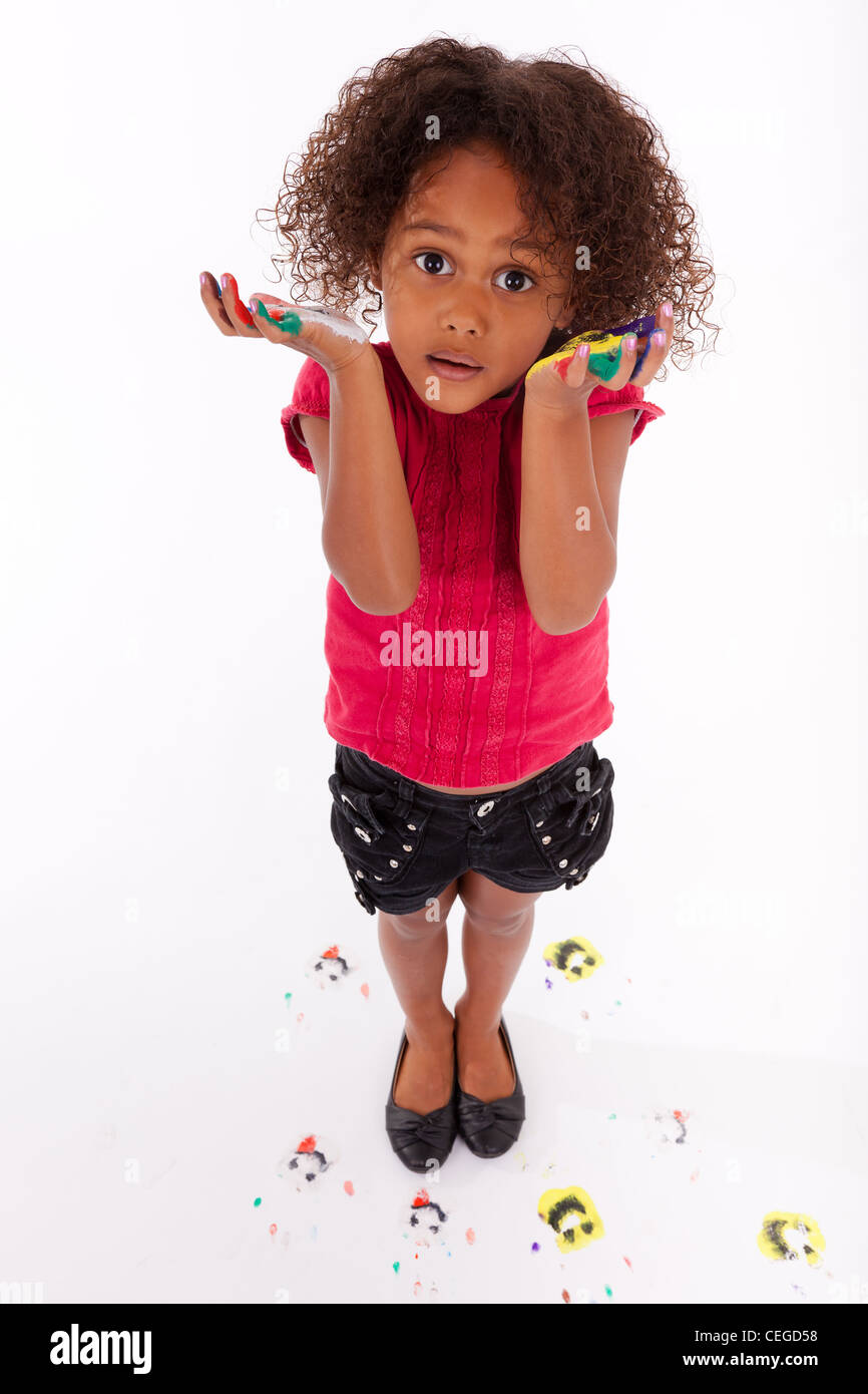 Little African Asian girl with painted hands in colorful paints Stock Photo