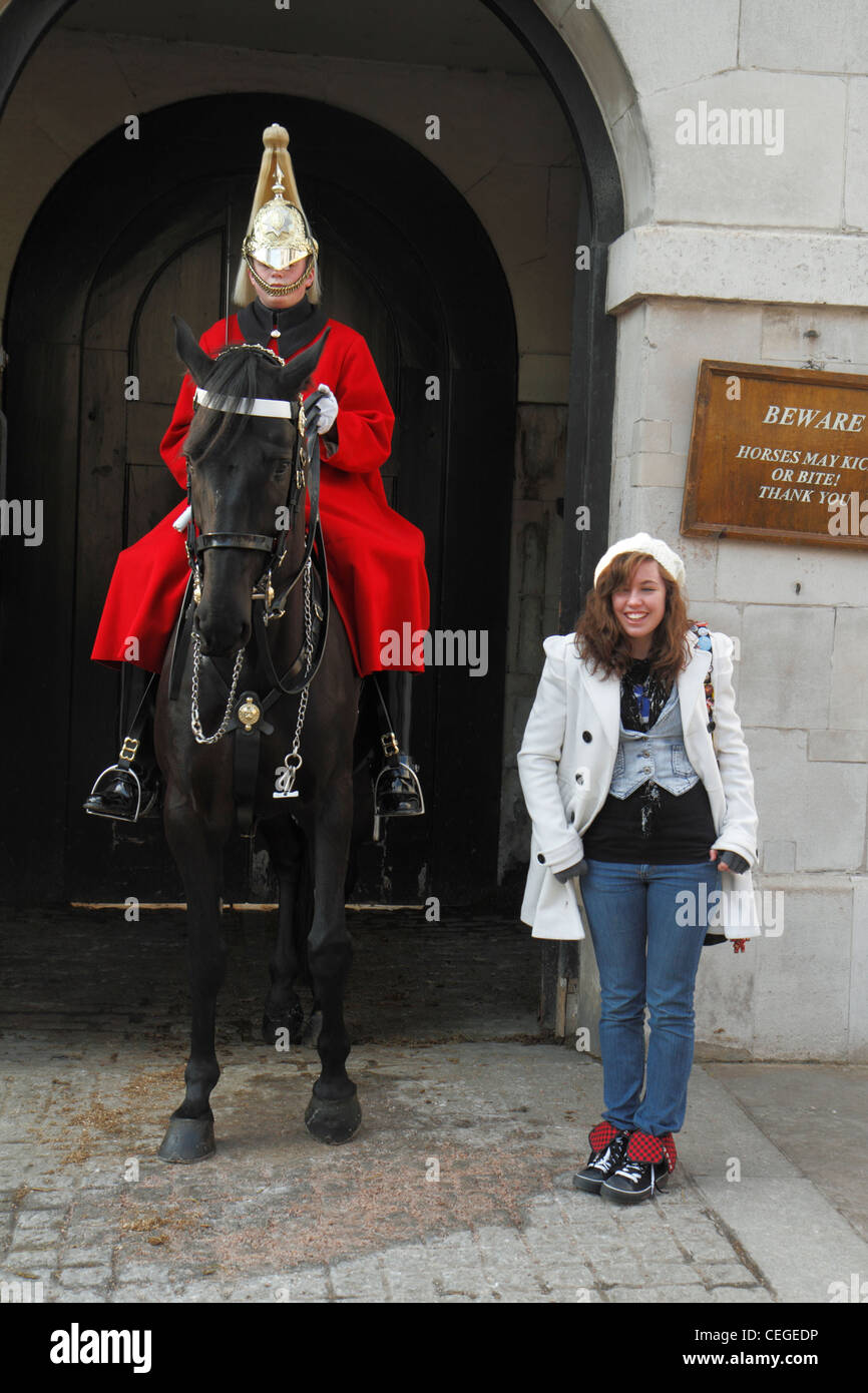Young female tourist posing with Household Cavalry, sentry, Horse Guards, London Stock Photo