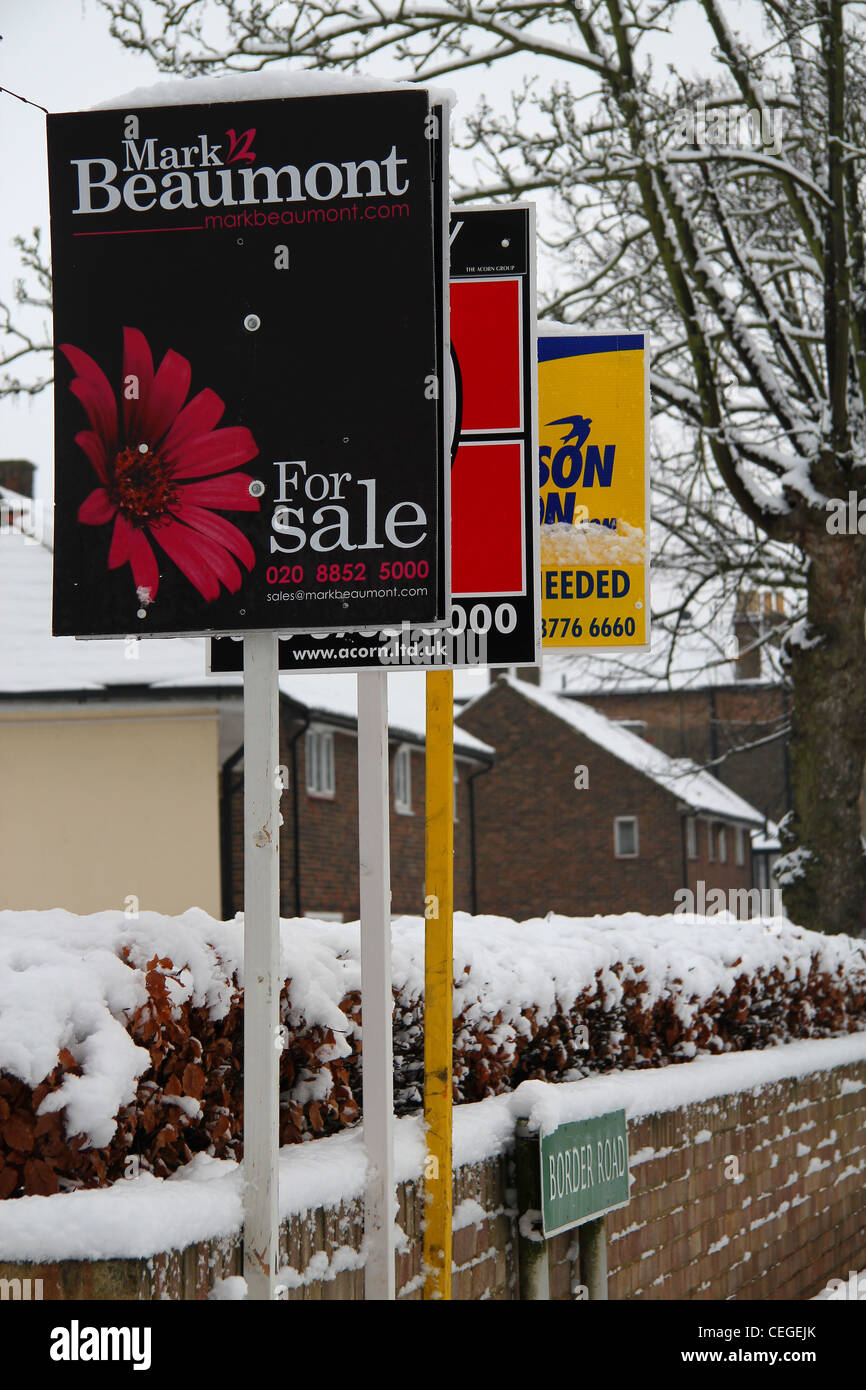 Estate agents advertising boards covered in snow Stock Photo