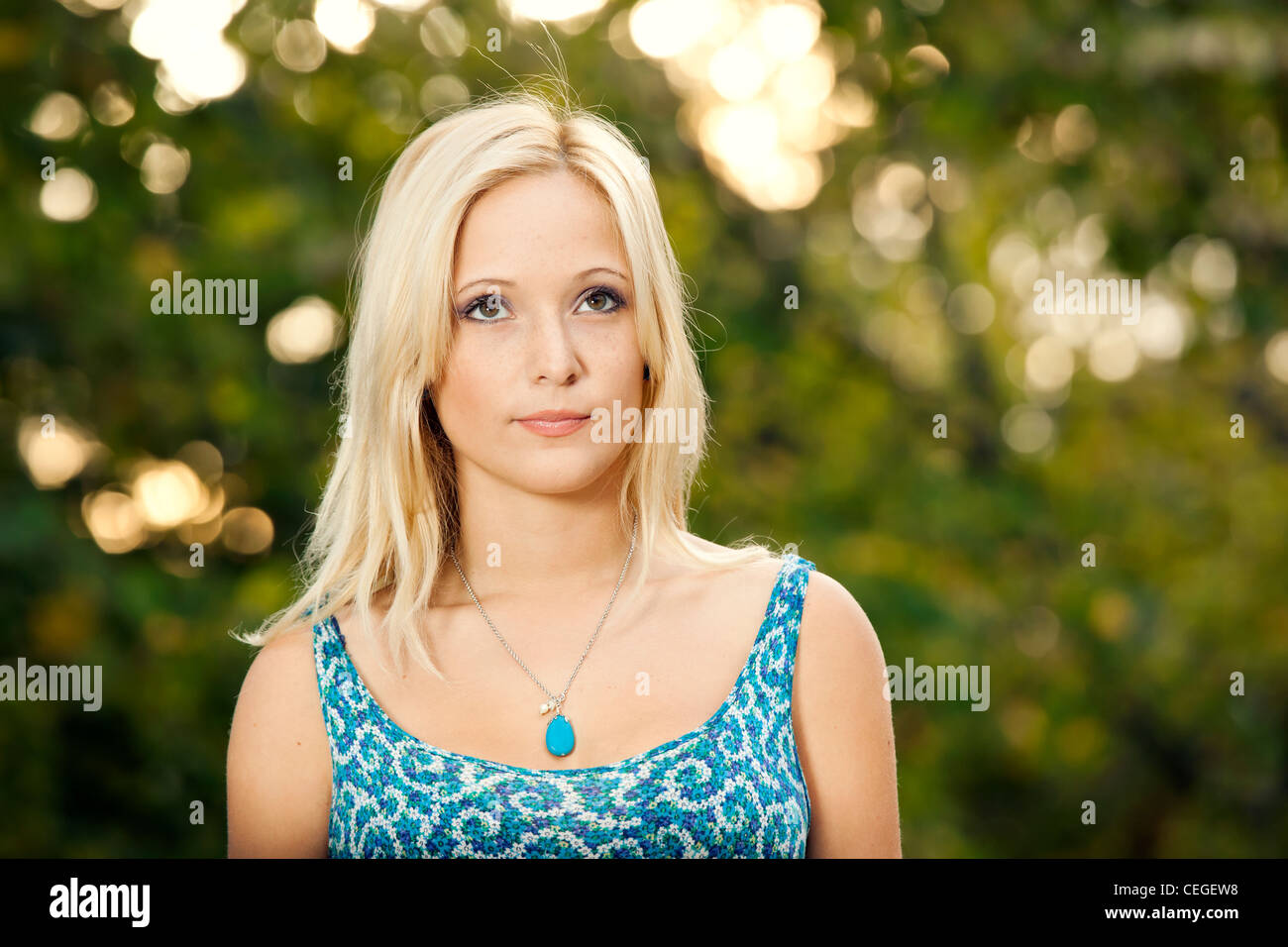 Outdoor portrait of a beautiful young woman in the park Stock Photo - Alamy