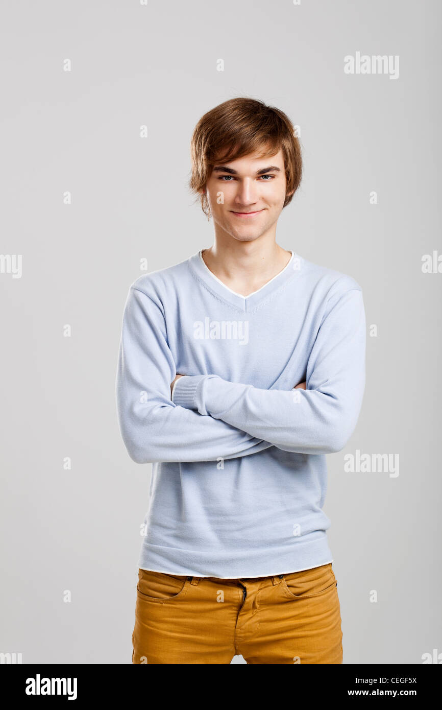 Portrait of a handsome young man standing over a gray background Stock ...