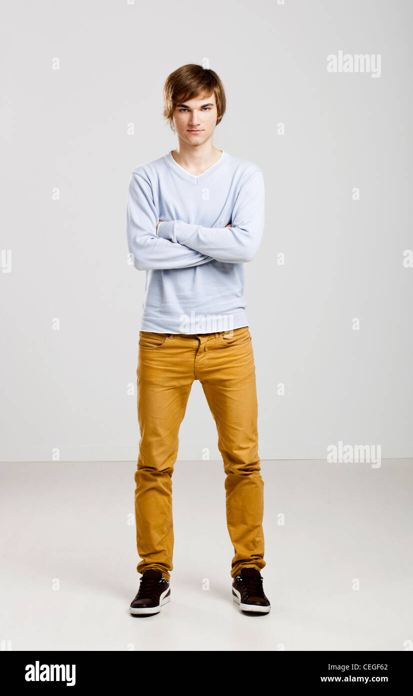 Portrait of a handsome young man standing over a gray background Stock ...