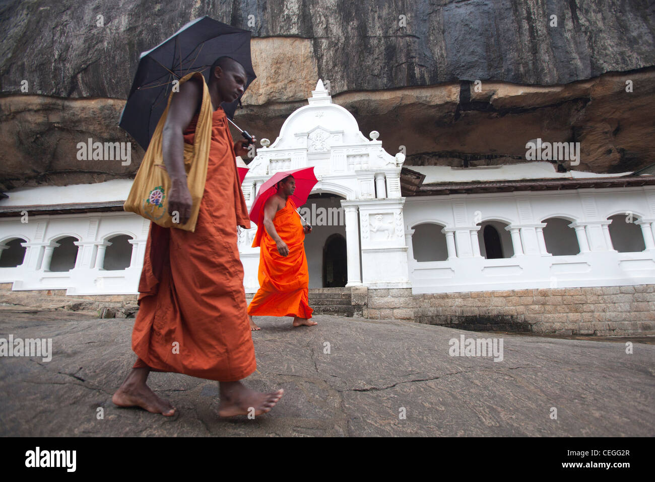 Two monks passing Royal Rock Temple Dambulla Sri Lanka Asia Stock Photo