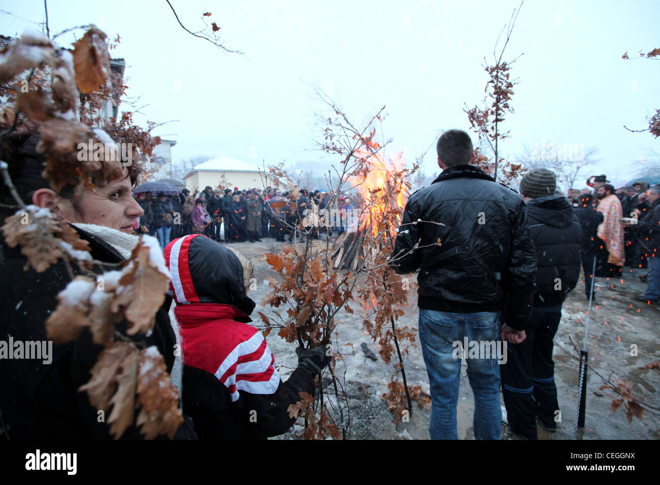 People waiting to place wood on the public campfire during orthodox christmas celebration in Mojkovac, Montenegro, Balkans Stock Photo