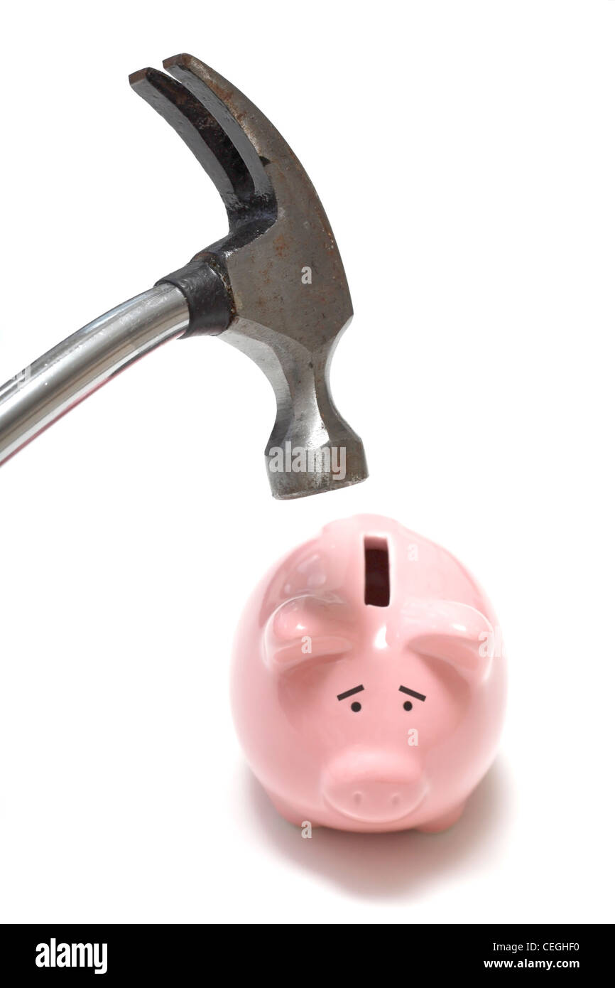 A hammer destroying a piggy bank Stock Photo Alamy