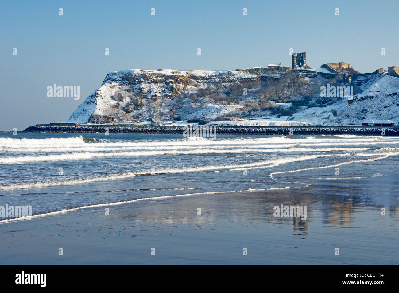 A snow covered Scarborough Castle headland and beach Stock Photo