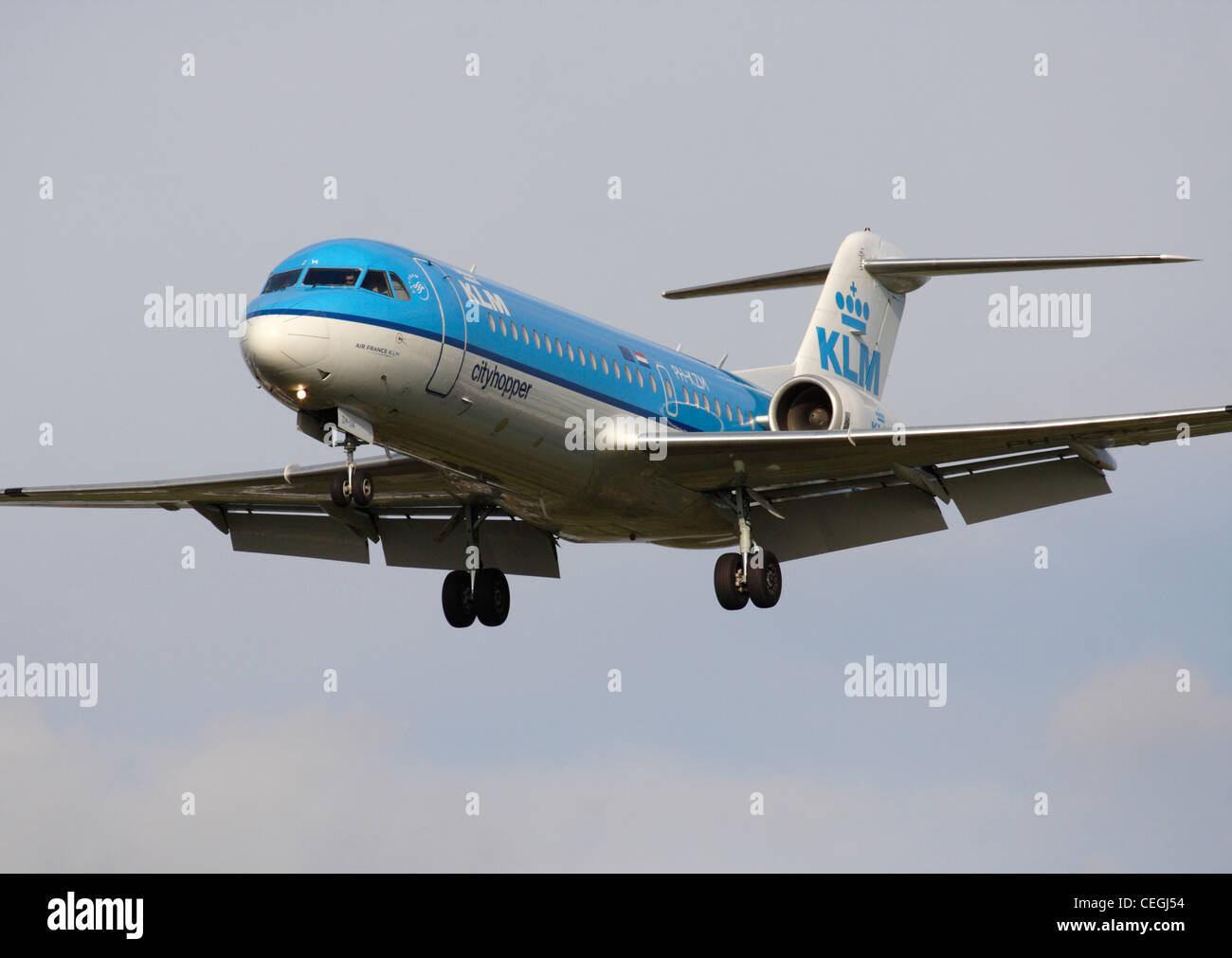 KLM Cityhopper Fokker 70 regional jet airliner on final approach. Close up front view. Stock Photo