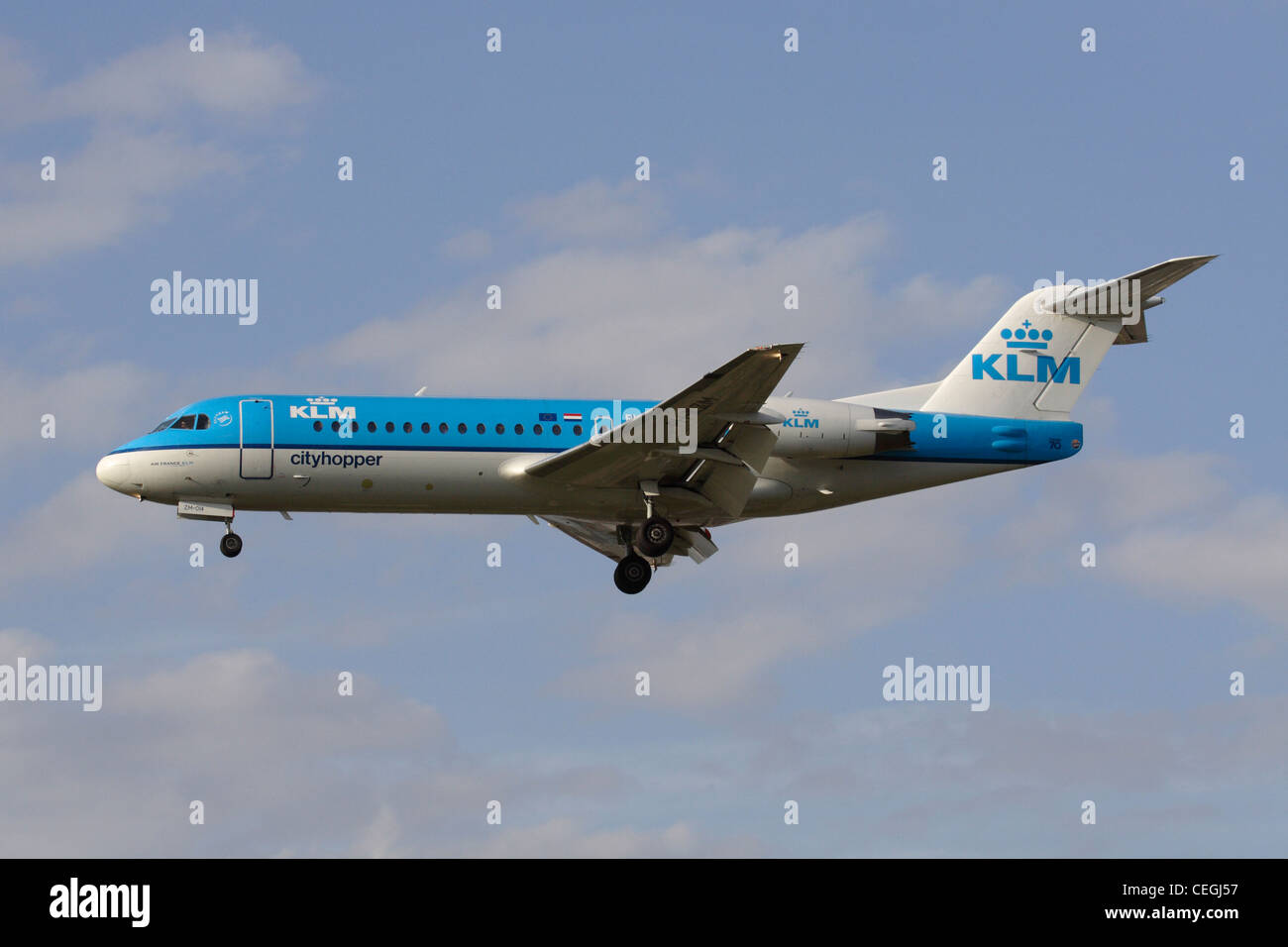 KLM Cityhopper Fokker 70 regional jet flying on approach. Side view. Stock Photo