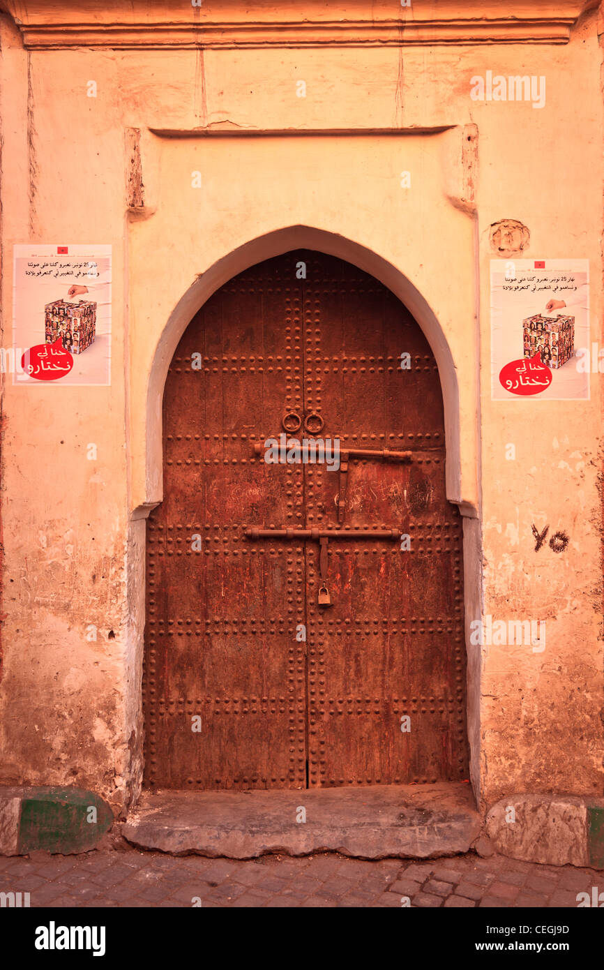 Moroccan door with election posters on the wall, Marrakech, Morocco Stock Photo