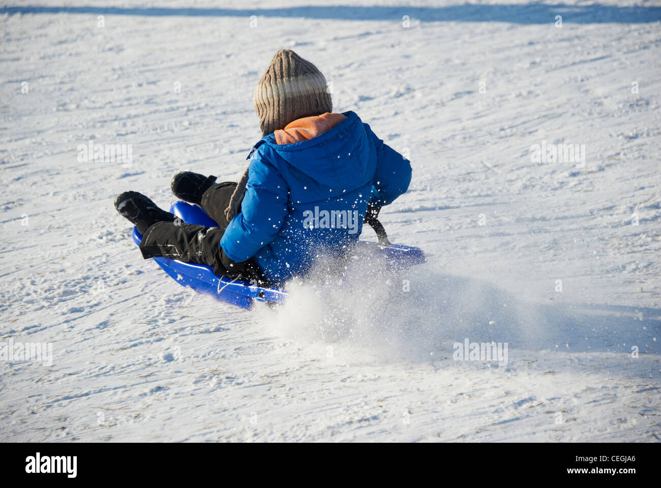 A child little boy sledding downhill winter Stock Photo Alamy