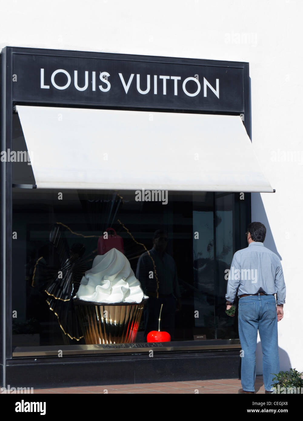 Man looking in shop window of Louis Vuitton in El Puerto José Banús, Marbella, Costa del Sol, Andalucia, Spain. Stock Photo