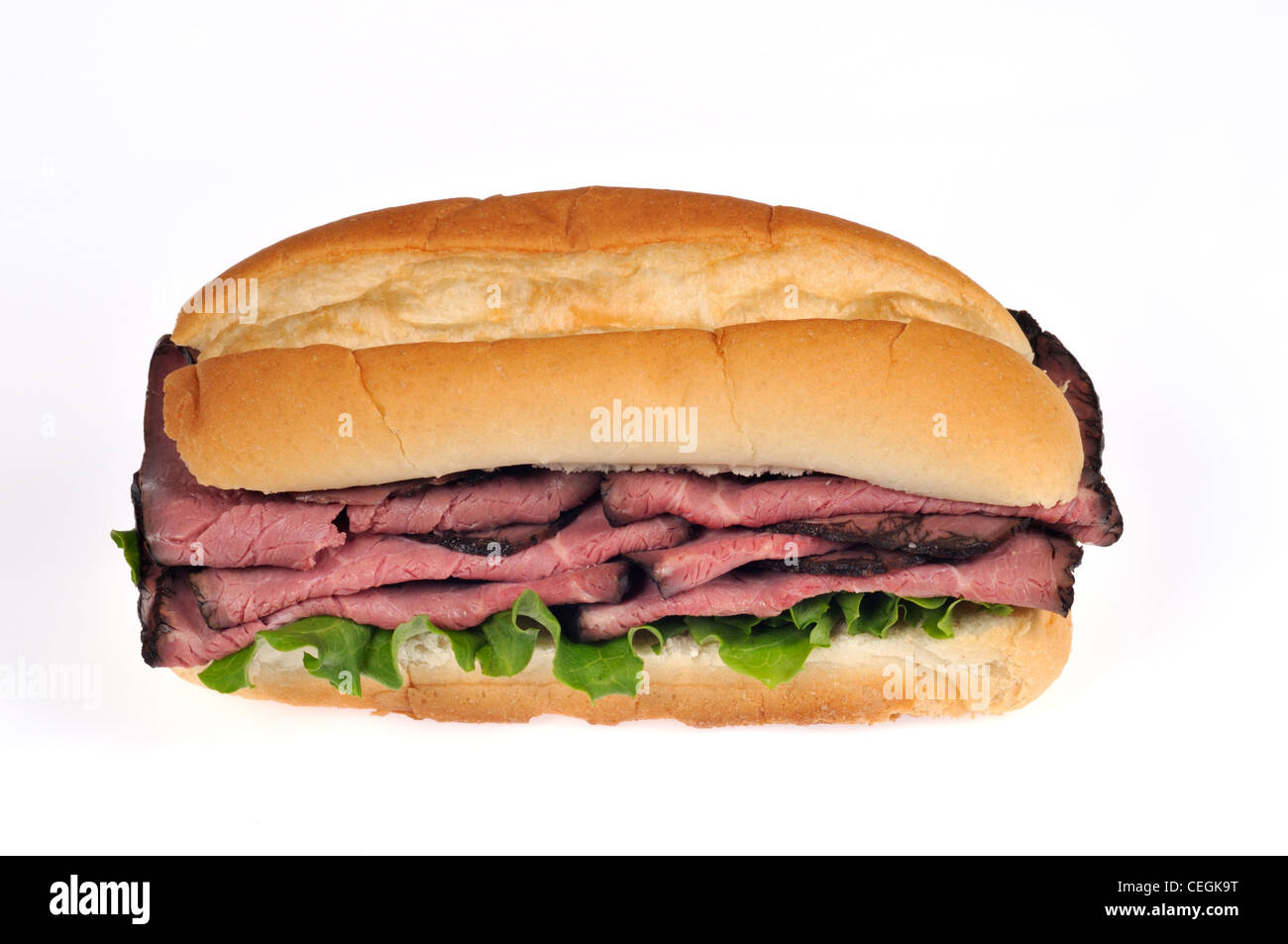 Roast beef sub sandwich with lettuce on bread roll on white background cutout. Stock Photo