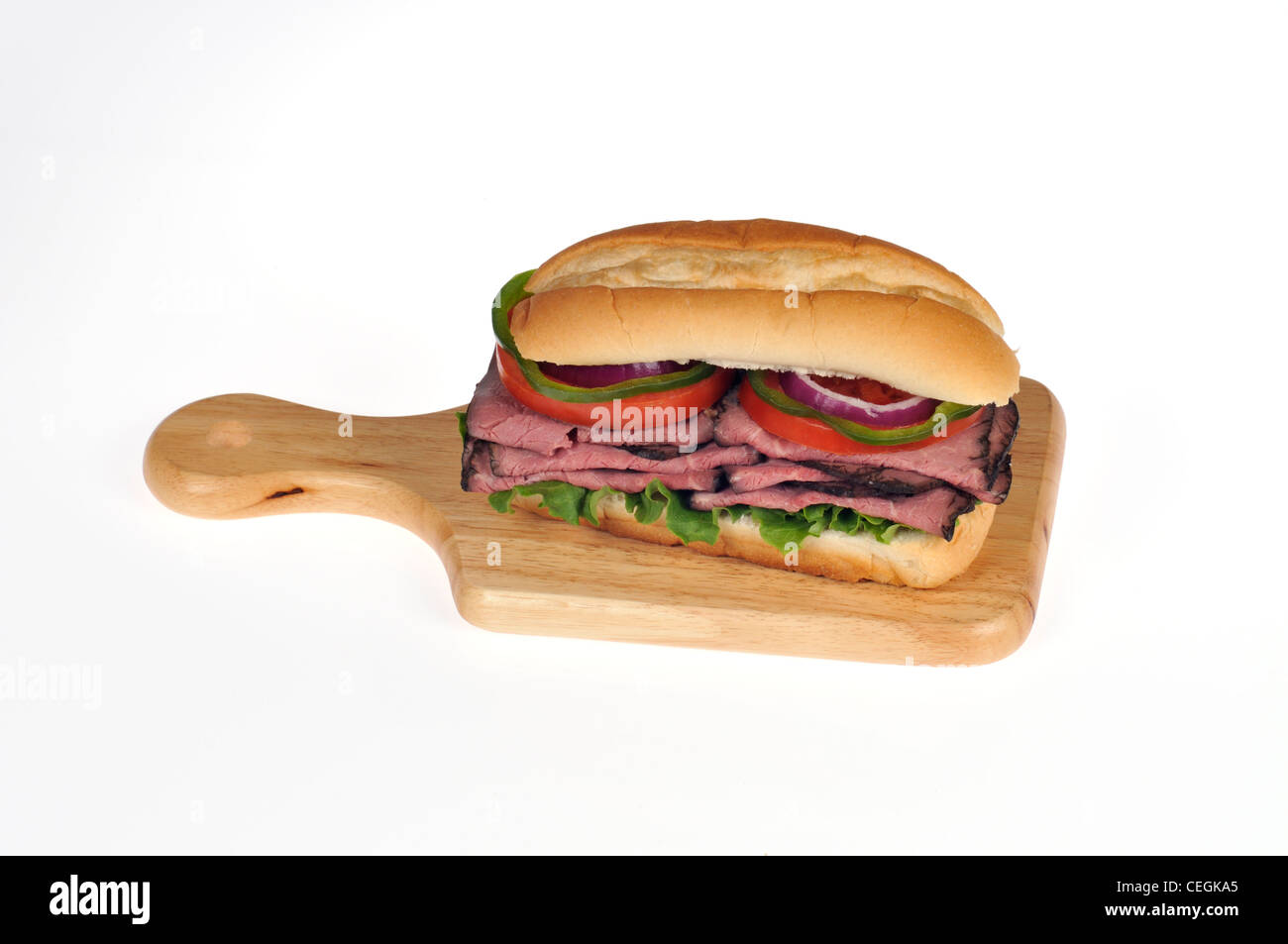 Roast beef with lettuce and tomato salad sandwich in bread submarine roll on wood deli board on white background isolated Stock Photo