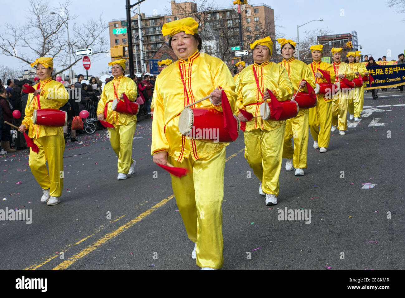 Falun Gong women dressed in yellow and playing traditional instruments in the 2012 Chinese Lunar New Year Parade in Flushing Stock Photo