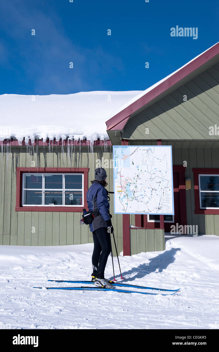 Cross country skier consulting the trail map of Camp Mercier, province of Quebec, Canada. Stock Photo
