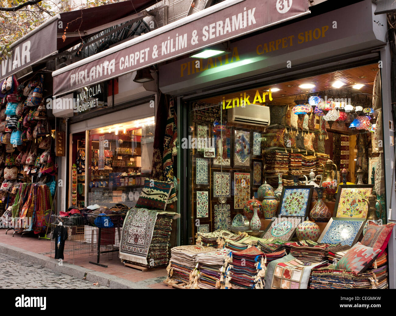Carpet and ceramic shops in Nuru Osmaniye St, Grand Bazaar, Beyazit, Istanbul, Turkey Stock Photo