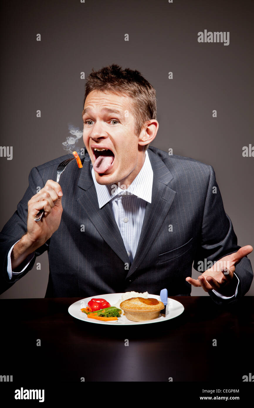 MAn burning his mouth on hot food Stock Photo Alamy