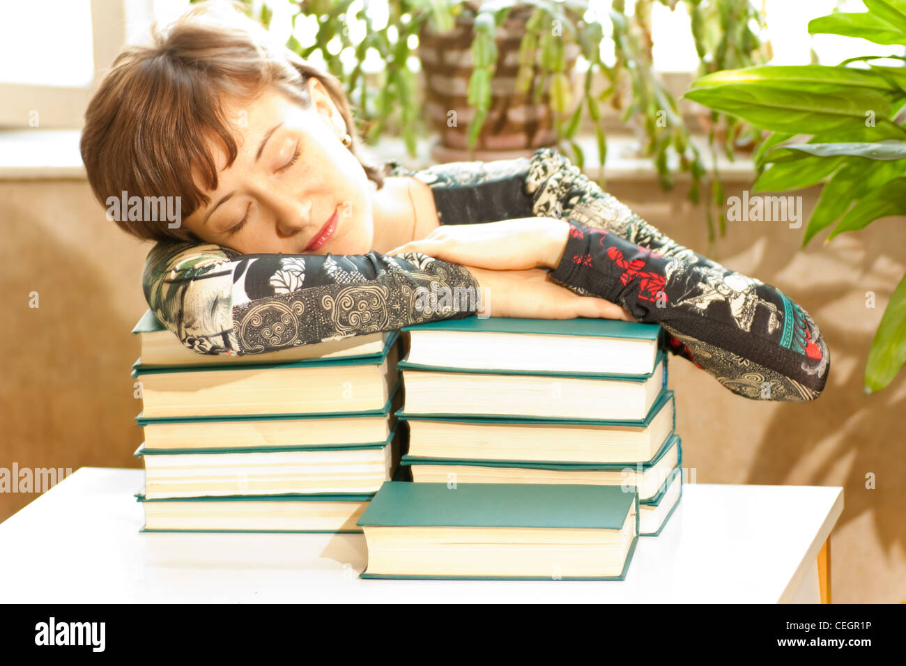 Woman sleeps while she books Stock Photo