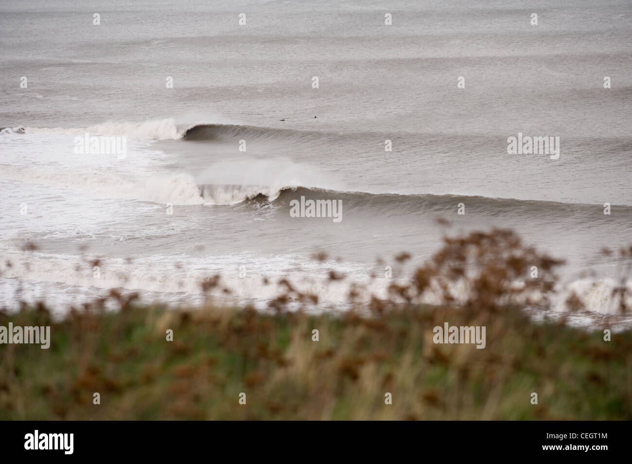 Waves break at a surfing spot along the Yorkshire coast. Stock Photo