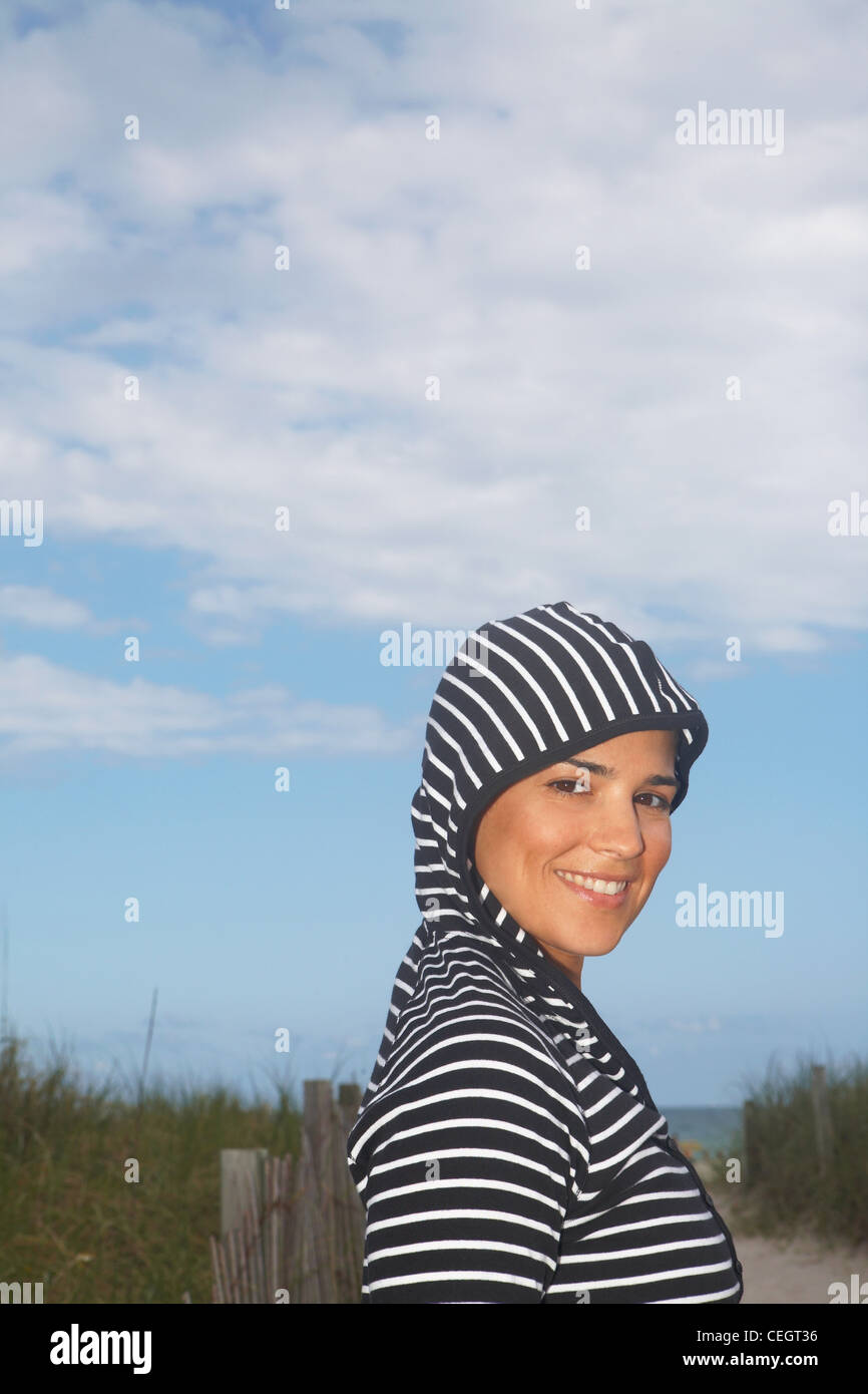 Portrait of mid adult woman in striped hooded top Stock Photo