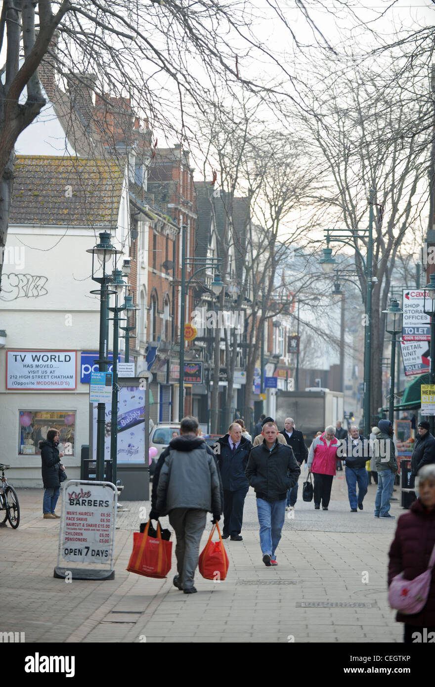 Chatham town centre Kent pedestrinised shopping area UK man carrying shopping bags Stock Photo