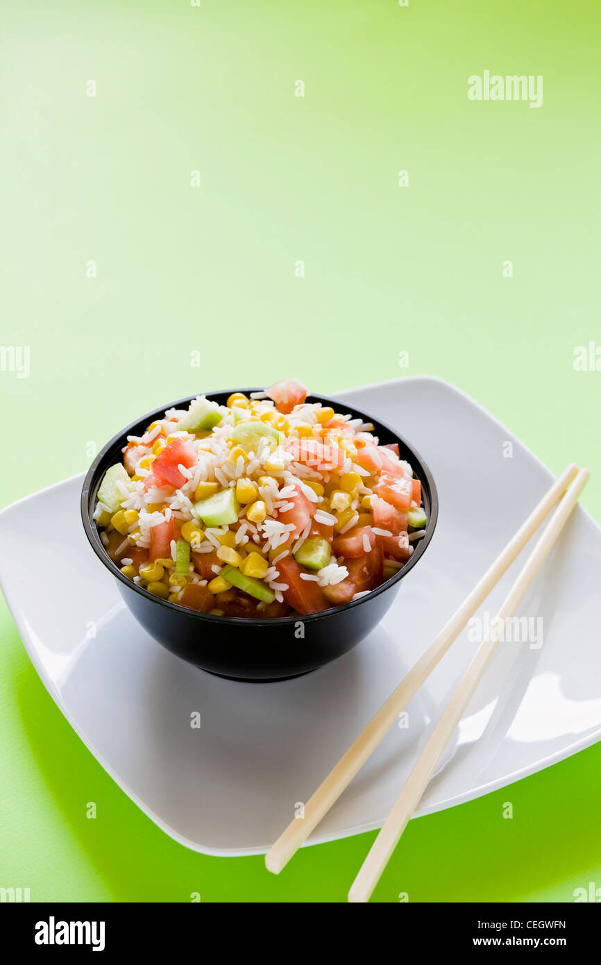 Photograph of a bowl of rice salad with corn tomato and cucumber Stock ...