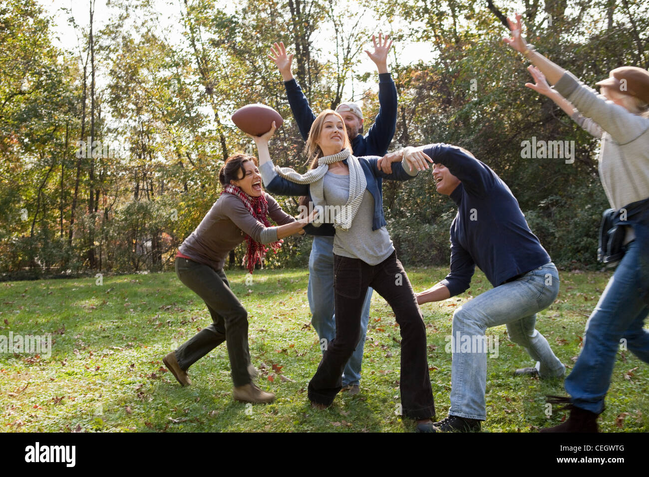 Mature friends playing football Stock Photo