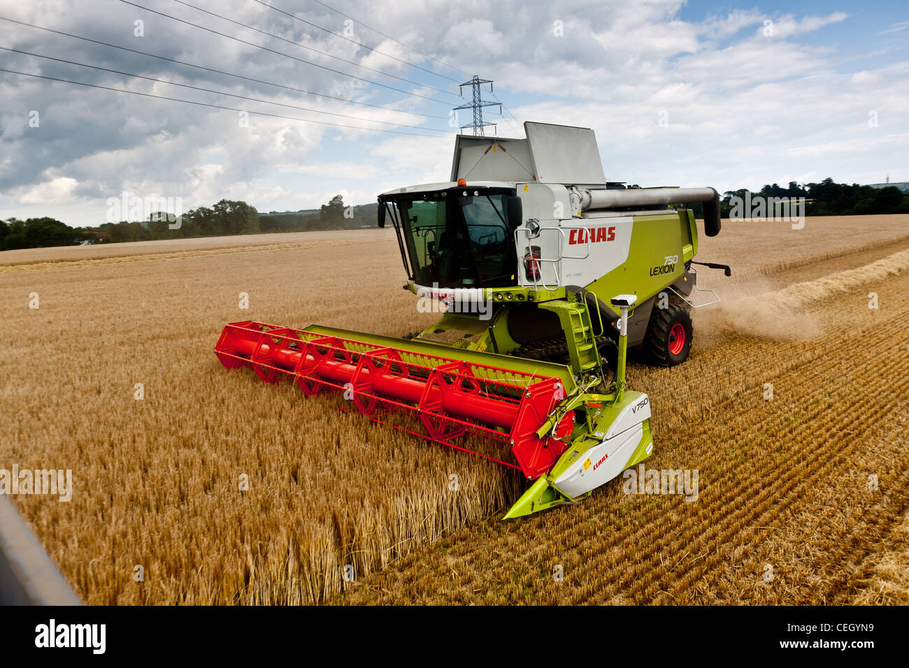 Barley being harvested by a claas combine in a field in Kent Stock Photo