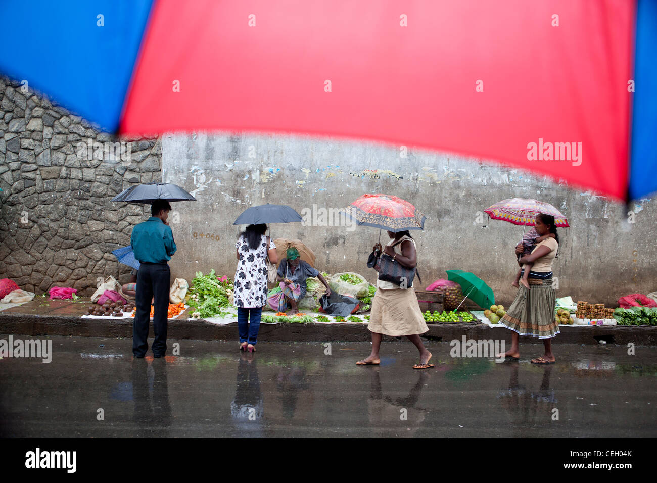 People on a rainy day at road side market Kandy Sri Lanka Asia Stock Photo