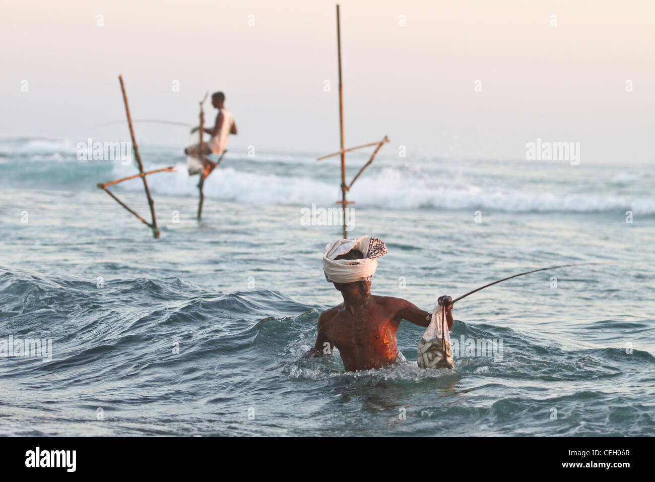 Stilt fishermen Indian Ocean Sri Lanka Asia Stock Photo
