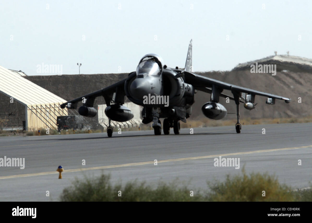 An AV-8B Harrier from Marine Attack Squadron 214, Marine Aircraft Group 40, Marine Expeditionary Brigade Afghanistan, taxis on the runway here following a successful mission in support of Marines with Regimental Combat Team 3 in the Helmand province. Stock Photo