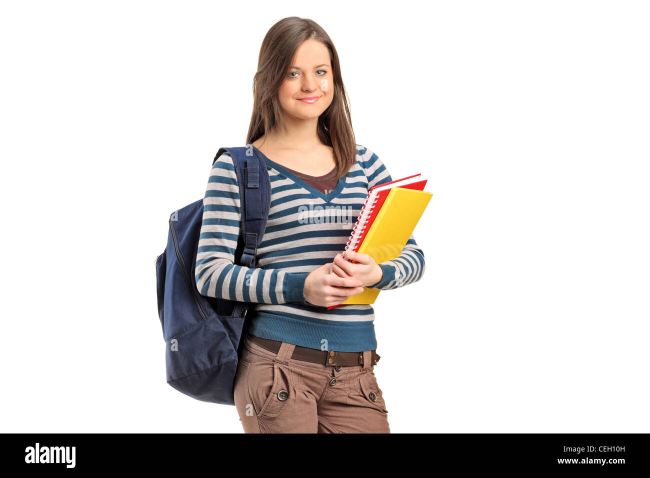 Smiling school girl posing with her books isolated on white background ...