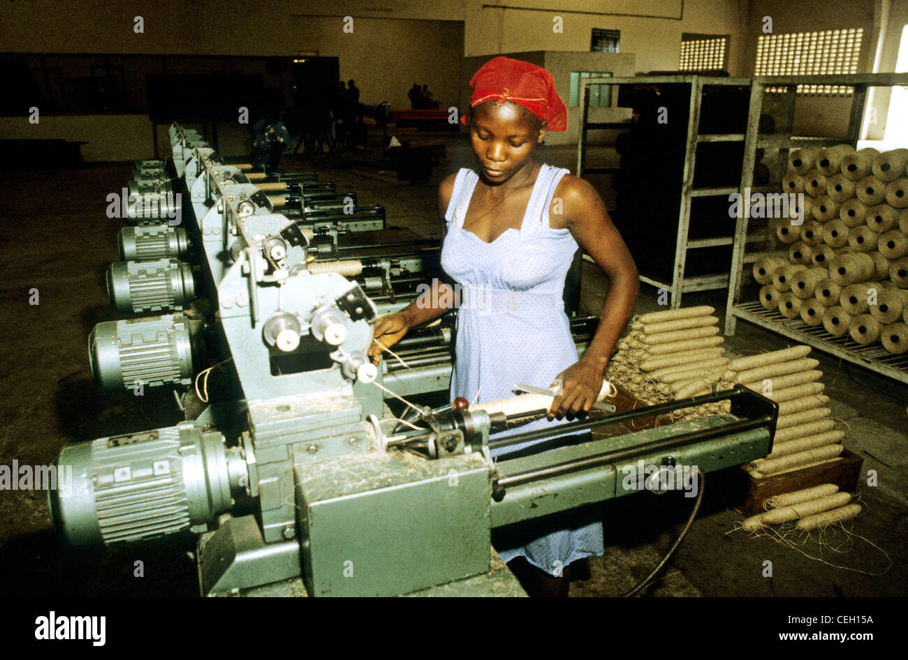 Kilosa Tanzania  East Africa -A young woman operates a row of machines which process sisal. Stock Photo