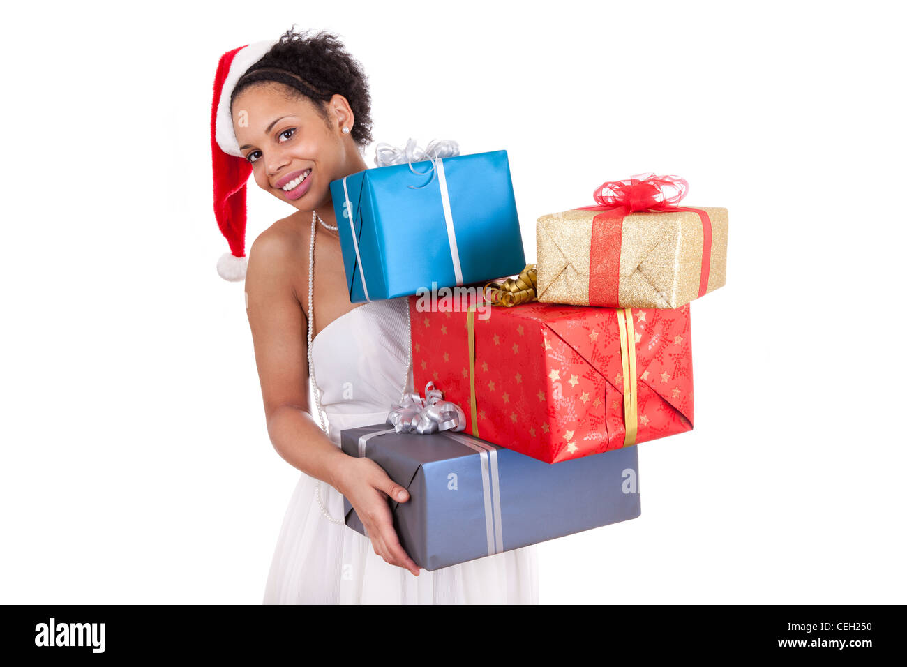 Young African American woman wearing a santa hat and holding a gift box ...